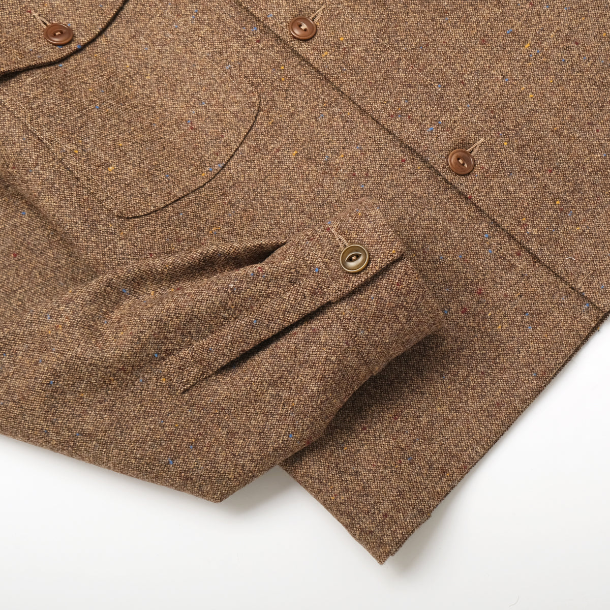 Brown wool camp shirt detail: flap chest pocket and buttoned placket
