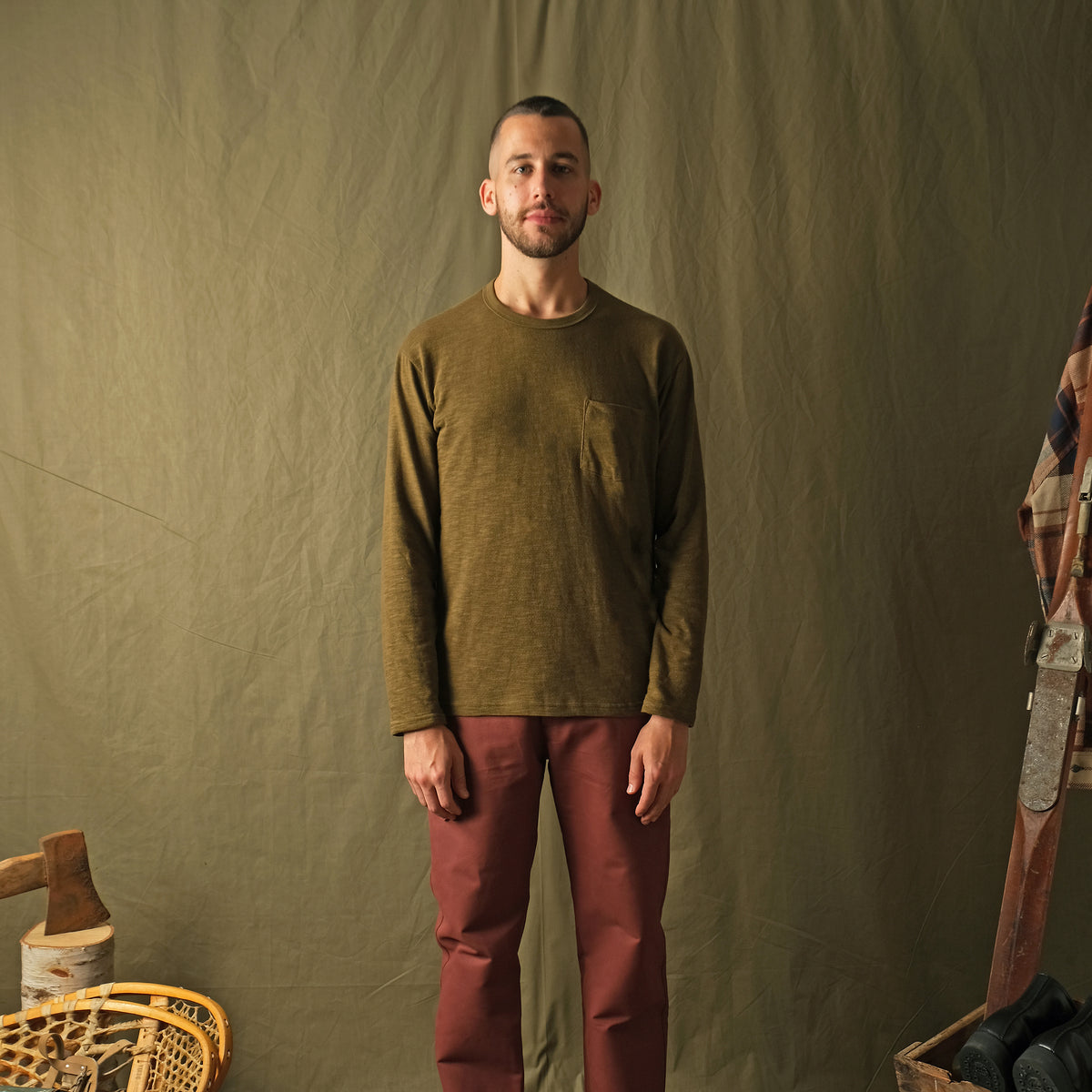 Olive long-sleeve pocket T-shirt on model, crew neck