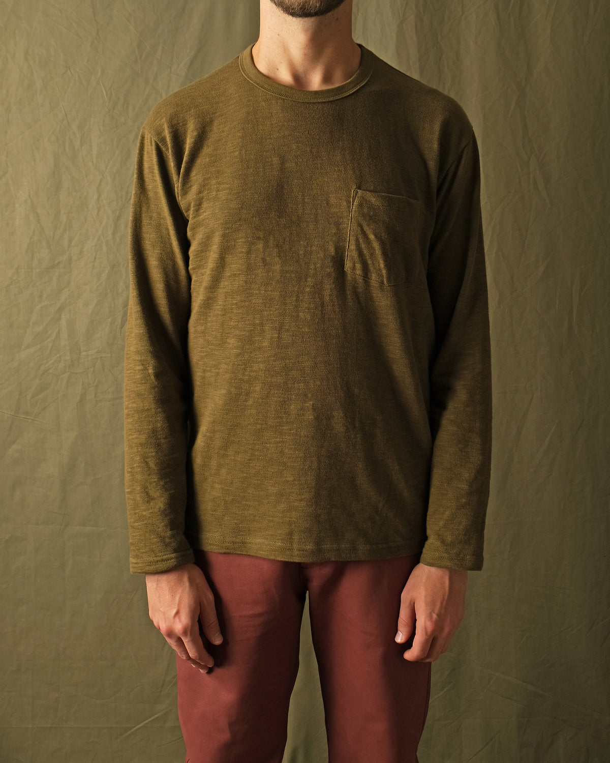Olive long-sleeve pocket T-shirt on model, textured slub knit