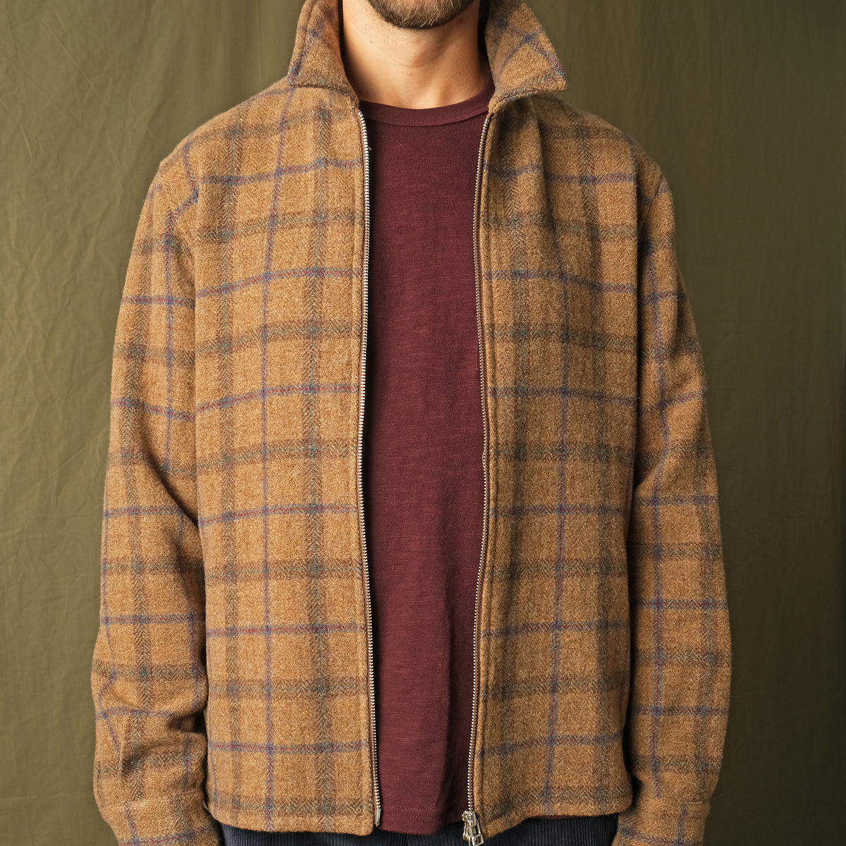 Wool plaid zip overshirt worn slightly open, collared neckline, metal zipper, cuffs
