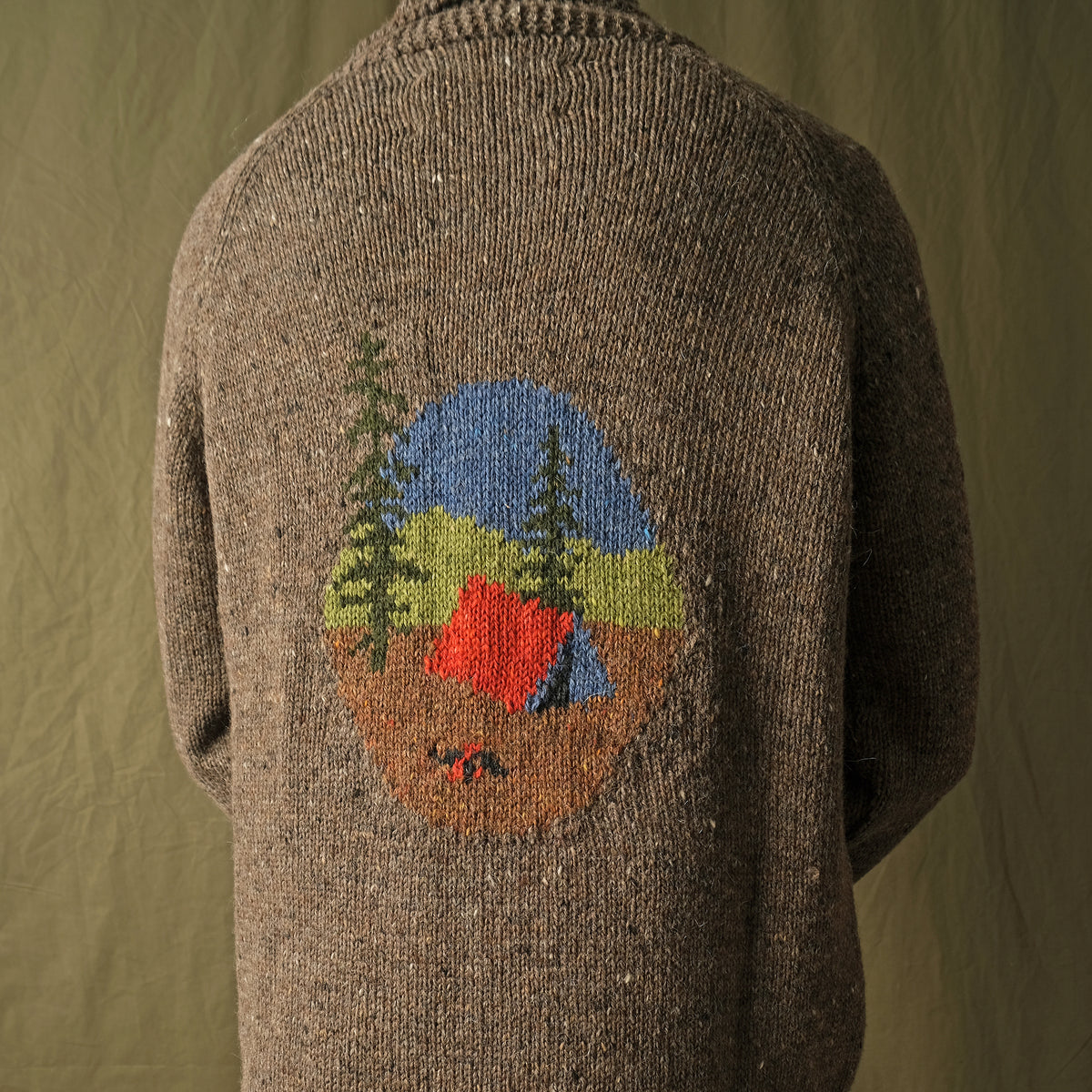 Brown full-zip cardigan worn by a man, camp scene motif centered on the back