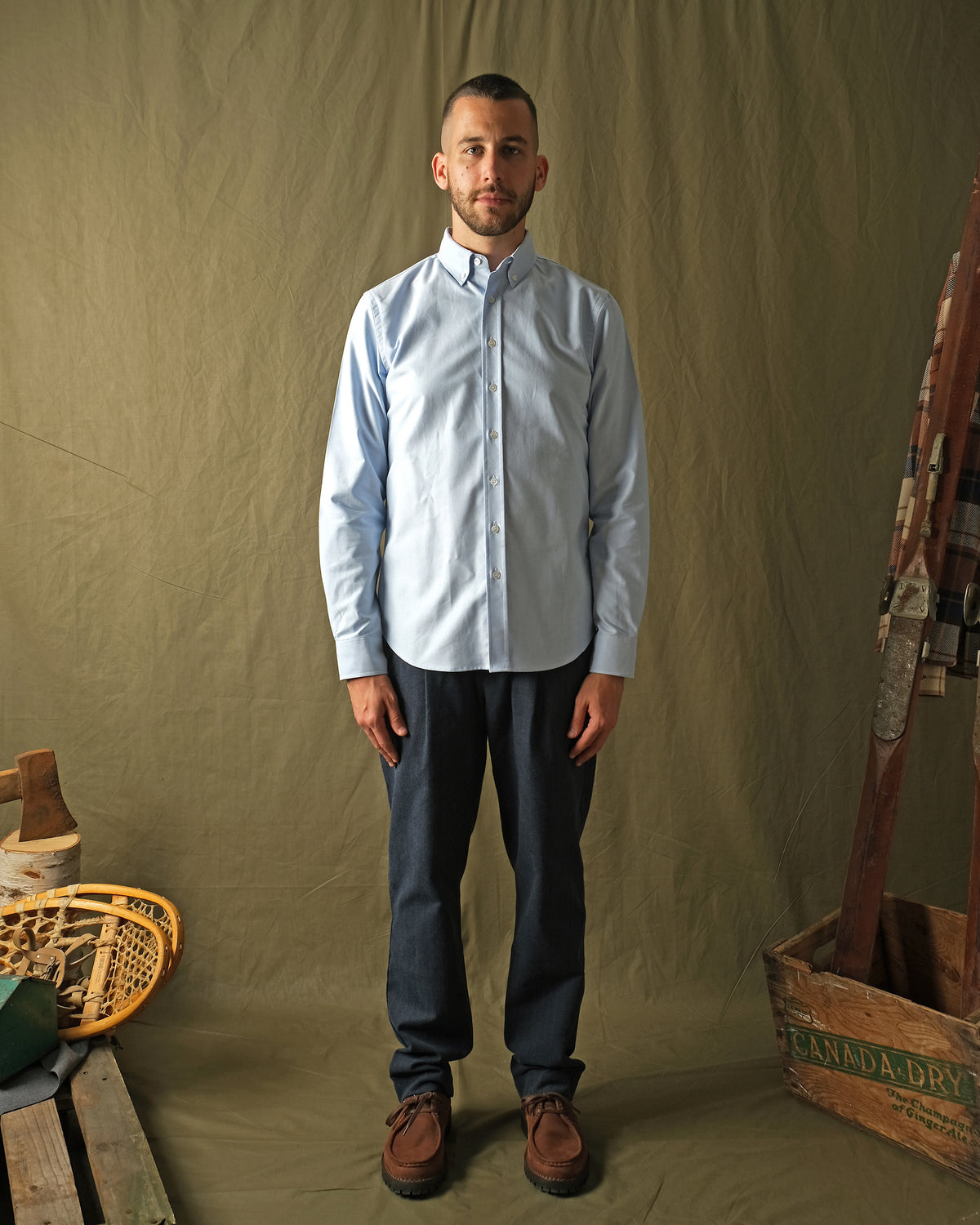 Light blue Oxford button-up shirt worn with dark trousers, long sleeves