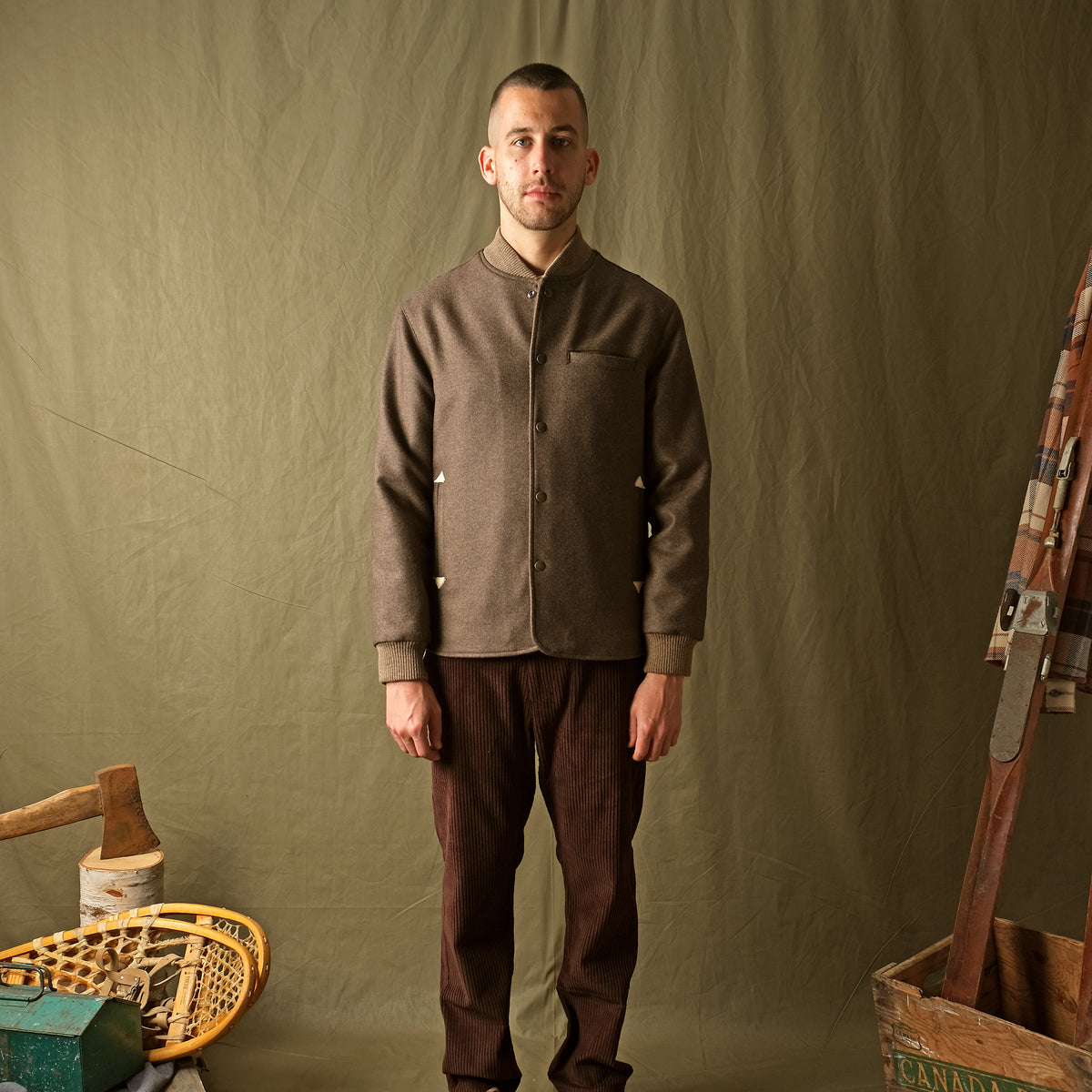 Mens brown stadium jacket with snap front, stand collar, chest pocket, ribbed cuffs