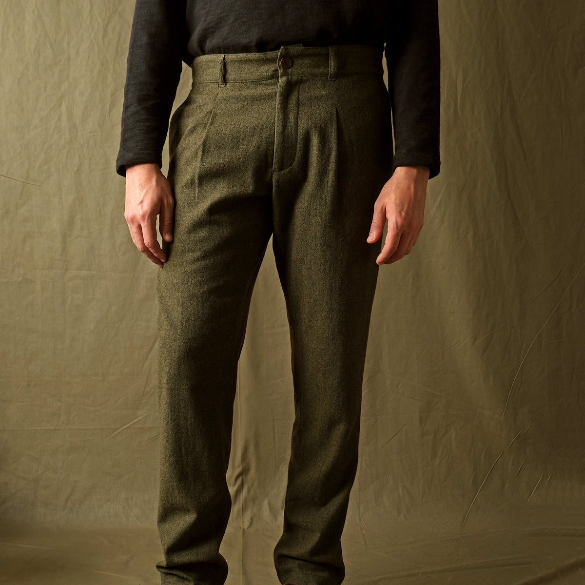 Olive washable wool pleated pants with front fly and side pockets, straight legs
