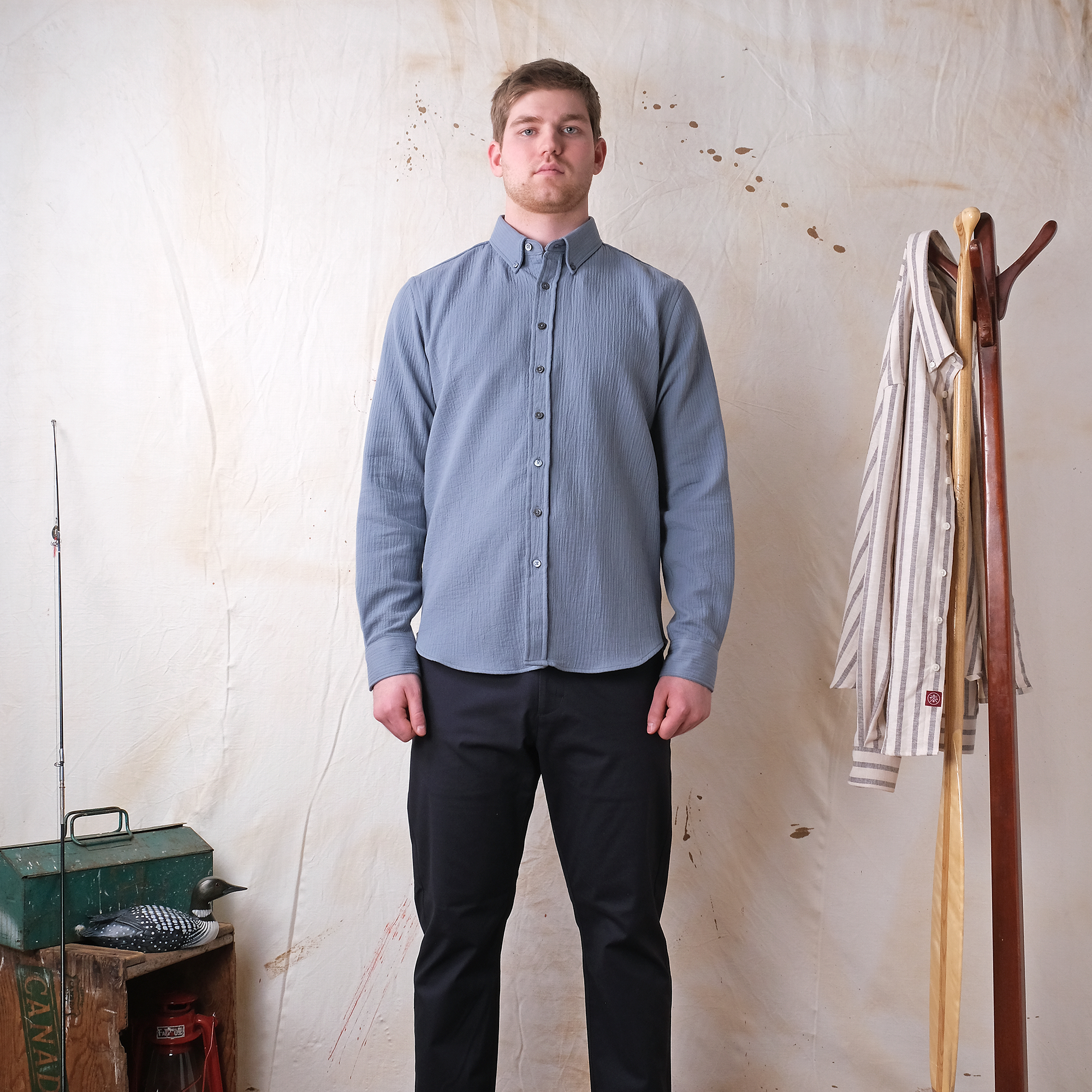 Slate blue quilted button-up shirt with long sleeves on a standing model