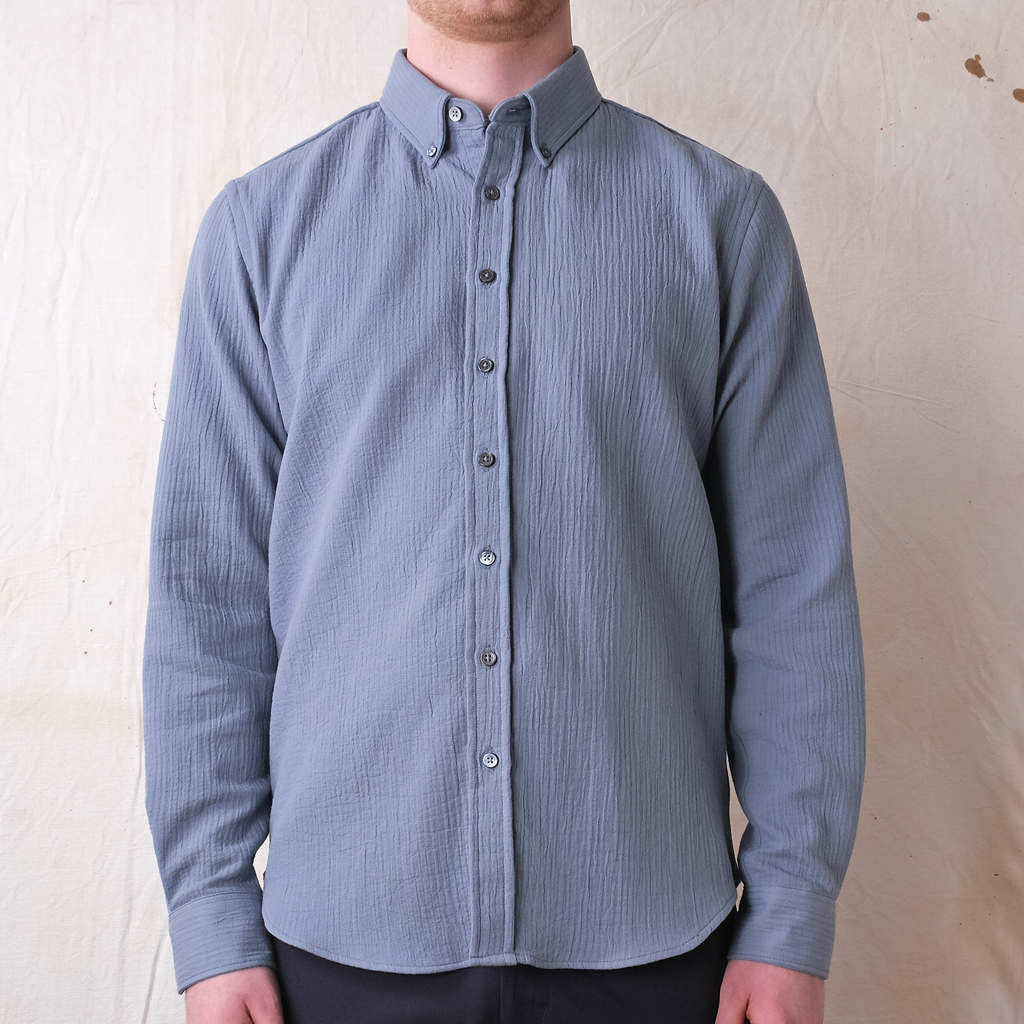 Slate blue quilted button-up shirt with point collar and button placket on model