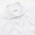 White dress shirt collar with spread neckline, button placket, and brand tag