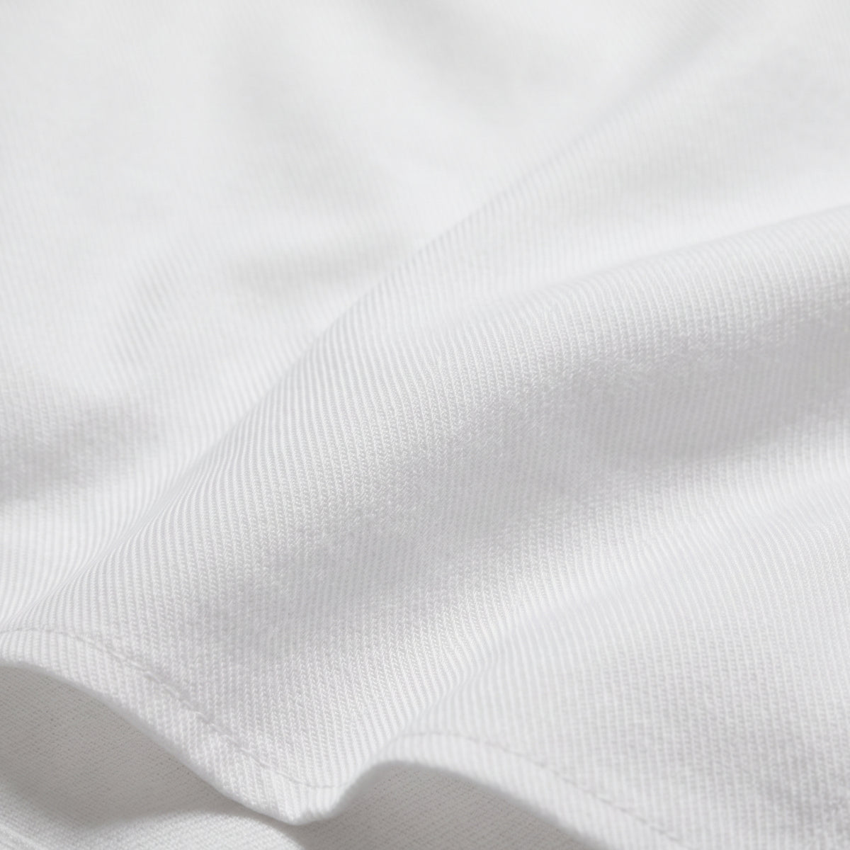White twill fabric close-up with fine textured weave