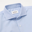 Light blue dress shirt collar with spread style and button placket, brand label