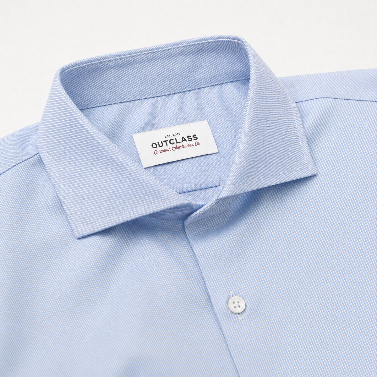 Light blue dress shirt collar with spread style and button placket, brand label