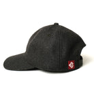 Dark charcoal wool field cap with side logo patch and curved brim