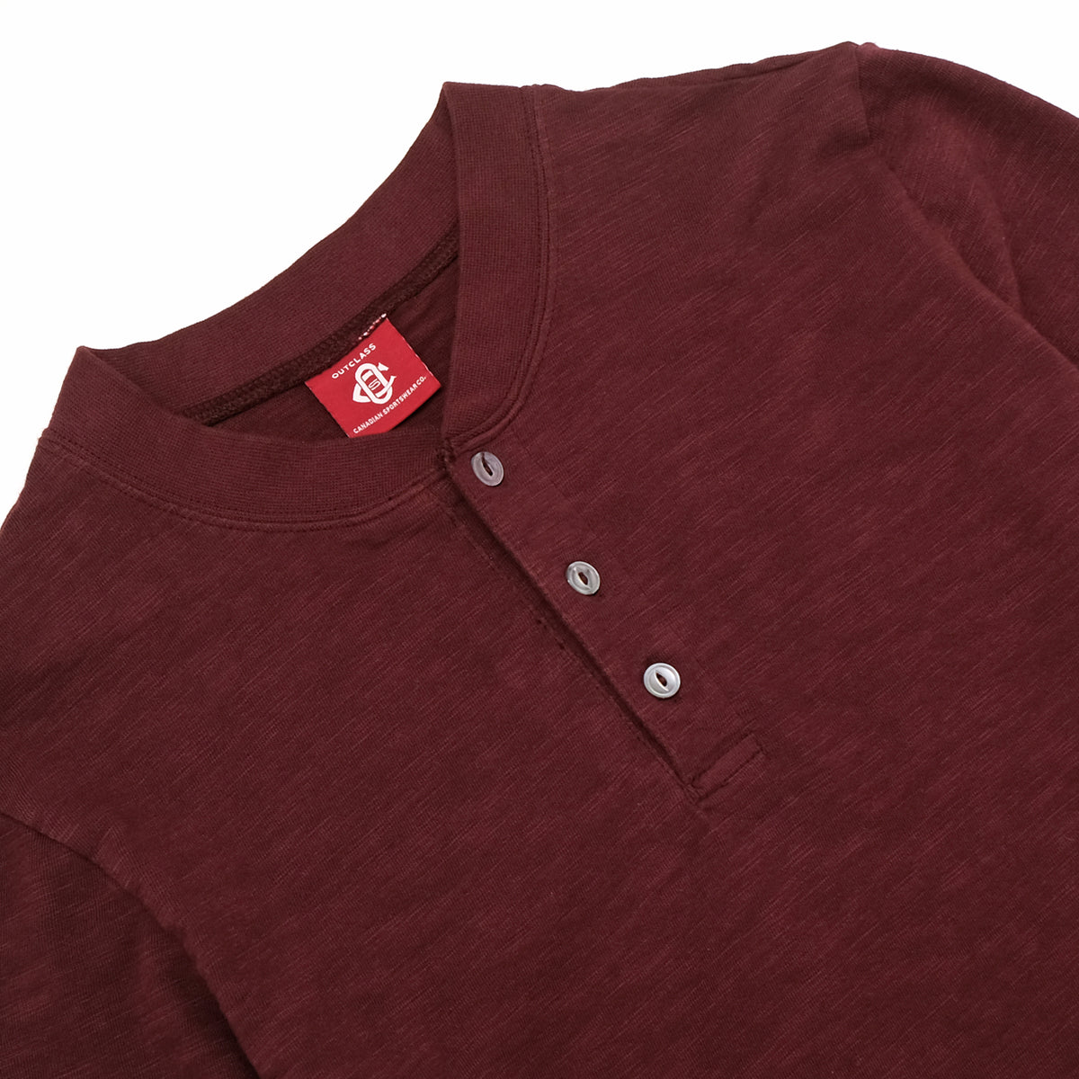 Maroon henley neckline with three button placket and woven brand tag