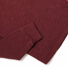 Maroon long-sleeve henley top with ribbed cuffs and button placket