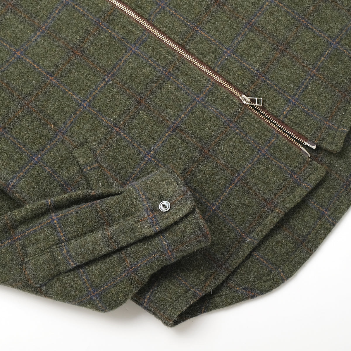Olive green plaid wool zip overshirt close-up of front zipper and button tab