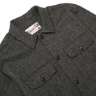 Charcoal fleck wool camp shirt close-up: camp collar, button placket, and flap pockets.
