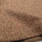 Hazel-fleck wool fabric close-up, speckled tweed weave texture