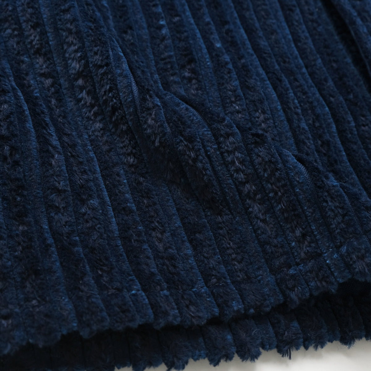 Navy jumbo corduroy fabric detail with dense vertical ribbed texture