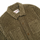 Olive jumbo corduroy club shirt close-up, soft-lined collar, button placket, chest pocket