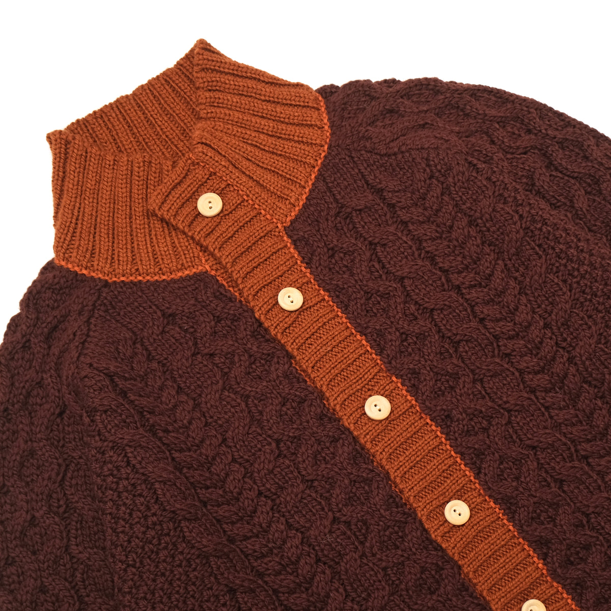 Dark maroon cable-knit cardigan close-up with orange mock neck and button placket