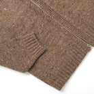 Brown knit cardigan sleeve cuff and side pocket with full-length silver zipper