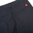 Navy pleated pants with front pockets and belt-loop waistband, logo patch at back