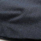 Navy herringbone fabric close-up with textured weave and subtle stripe pattern