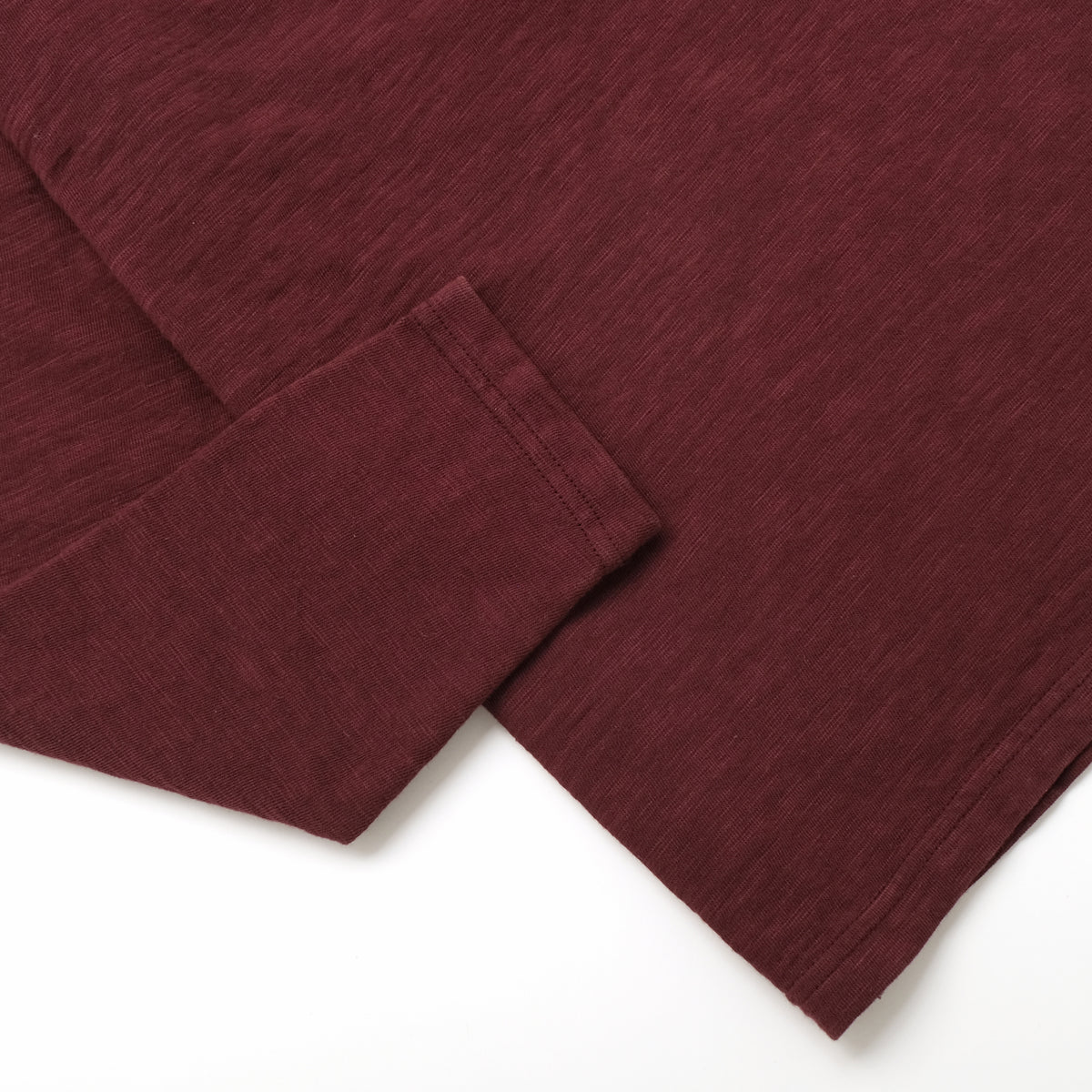 Maroon long-sleeve T-shirt cuffs and hem detail, double slub knit.