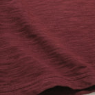 Maroon double slub long-sleeve T-shirt fabric close-up, textured weave.