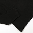 Black long-sleeve T-shirt with straight hem and visible side seam stitching