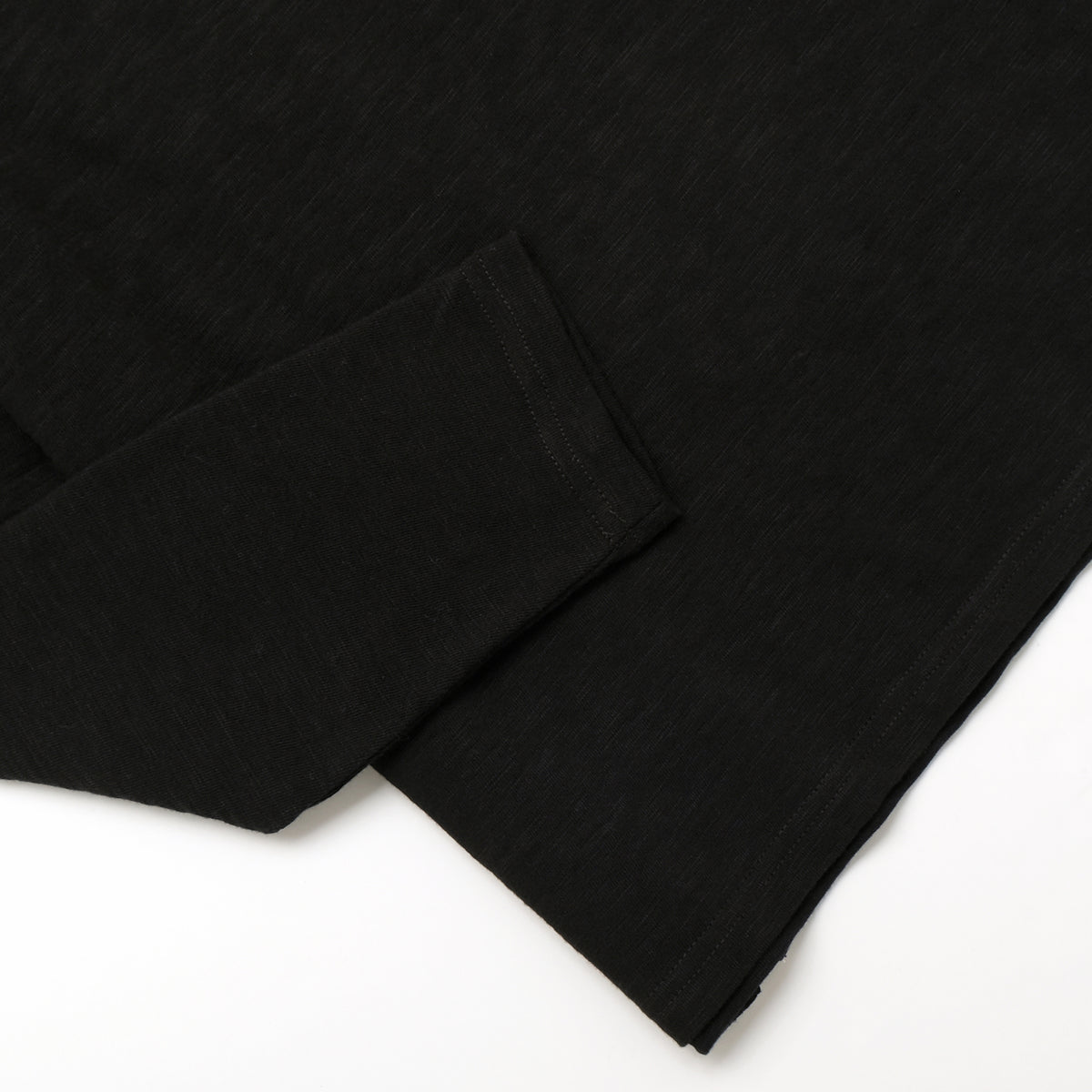 Black long-sleeve T-shirt with straight hem and visible side seam stitching