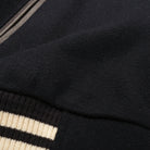 Navy bomber jacket fabric and striped ribbed cuff detail