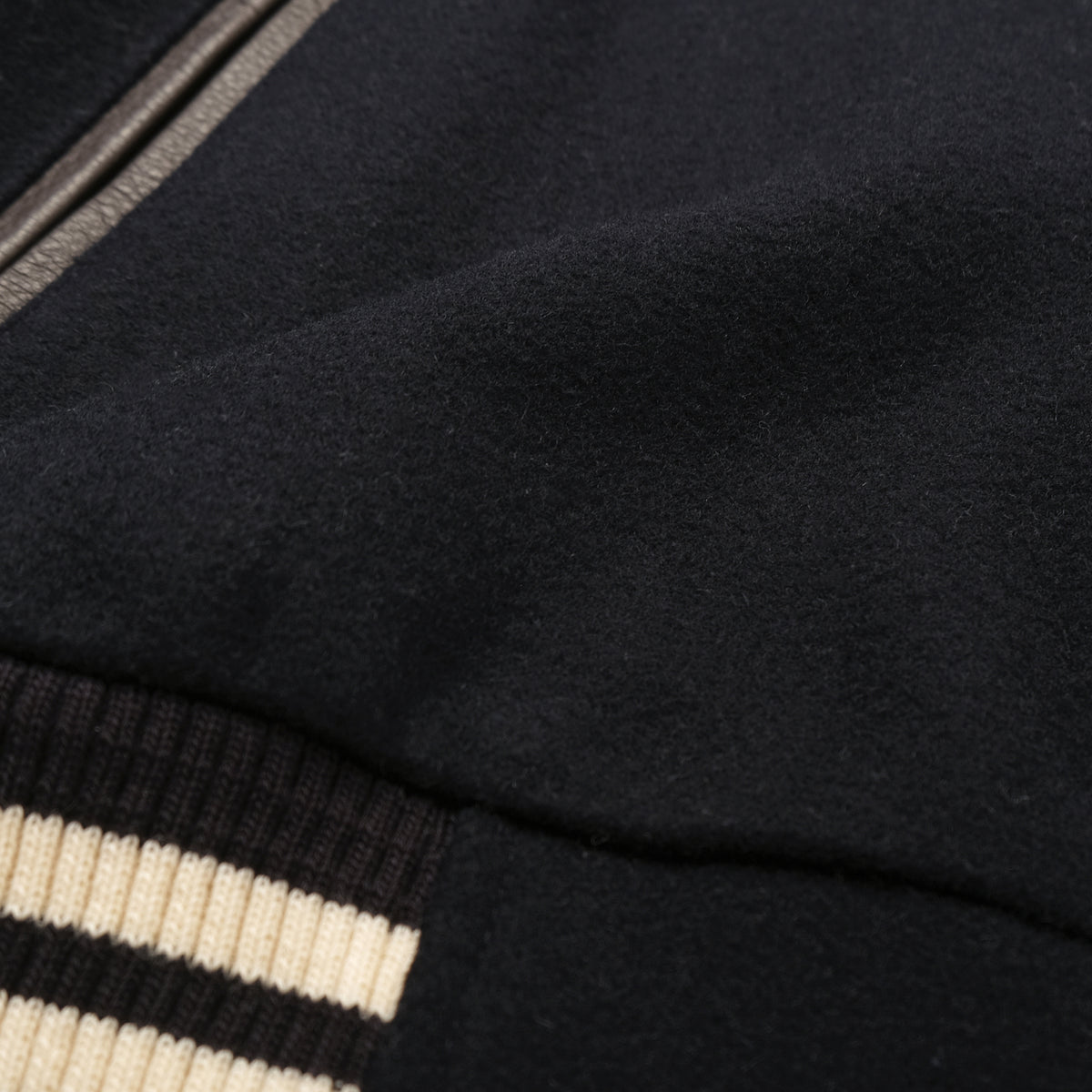 Navy bomber jacket fabric and striped ribbed cuff detail