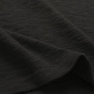 Black slub knit T-shirt fabric close-up