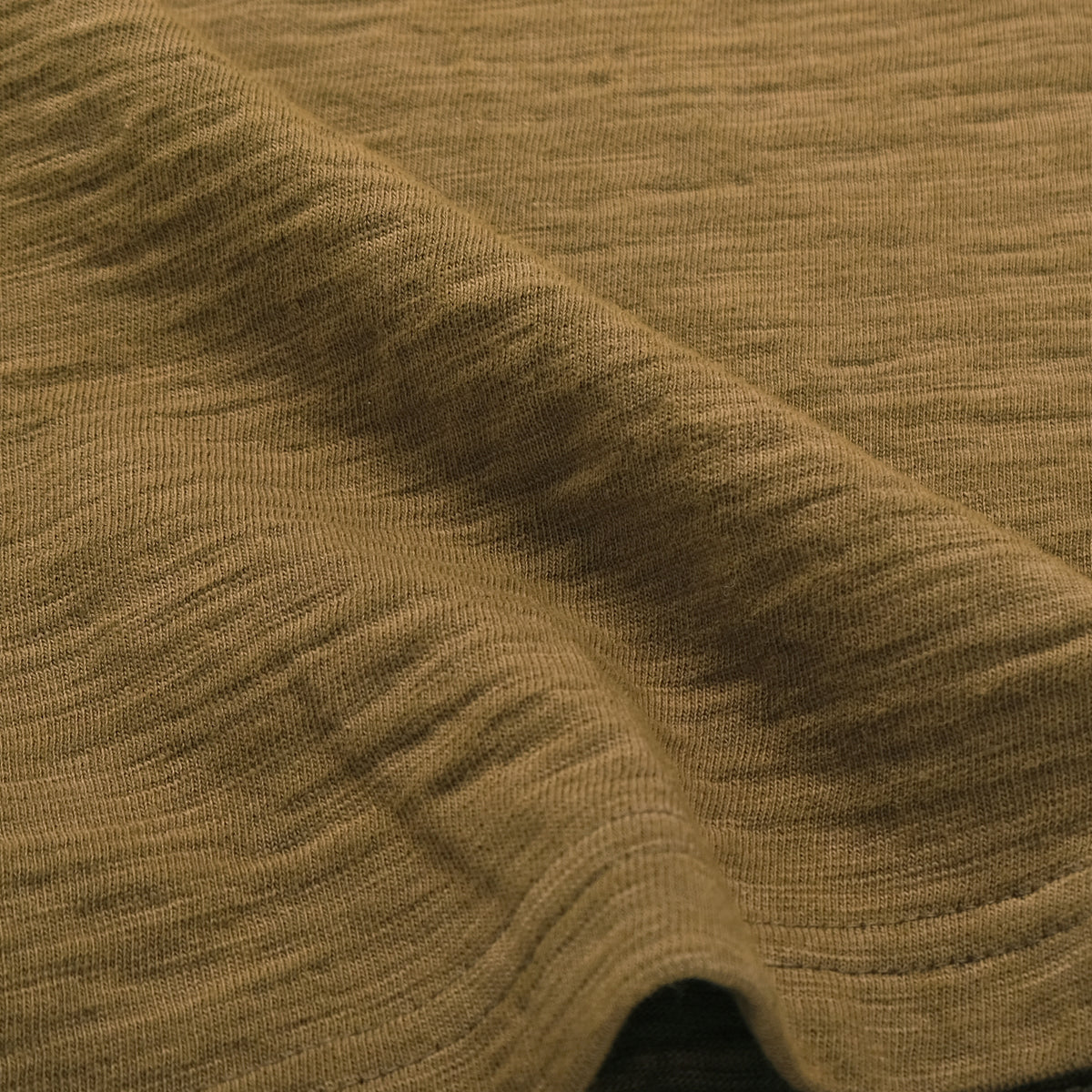 Olive textured double slub knit fabric close-up