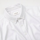 White Oxford shirt neckline with collar, front buttons, and label
