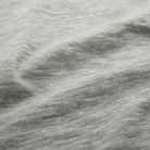 Heather grey slub knit fabric close-up with visible textured slub pattern