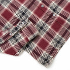 Maroon plaid shirt with button placket, collar, and long cuffed sleeves