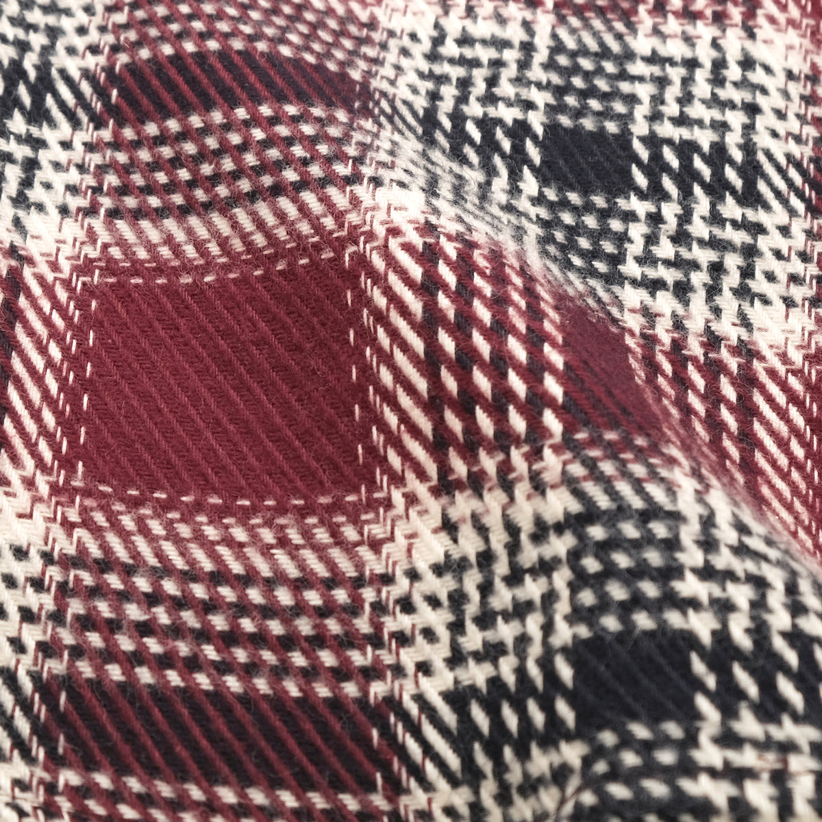 Maroon plaid flannel fabric with cream and black check pattern