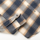 Blue and cream plaid flannel shirt sleeve with button cuff and seam
