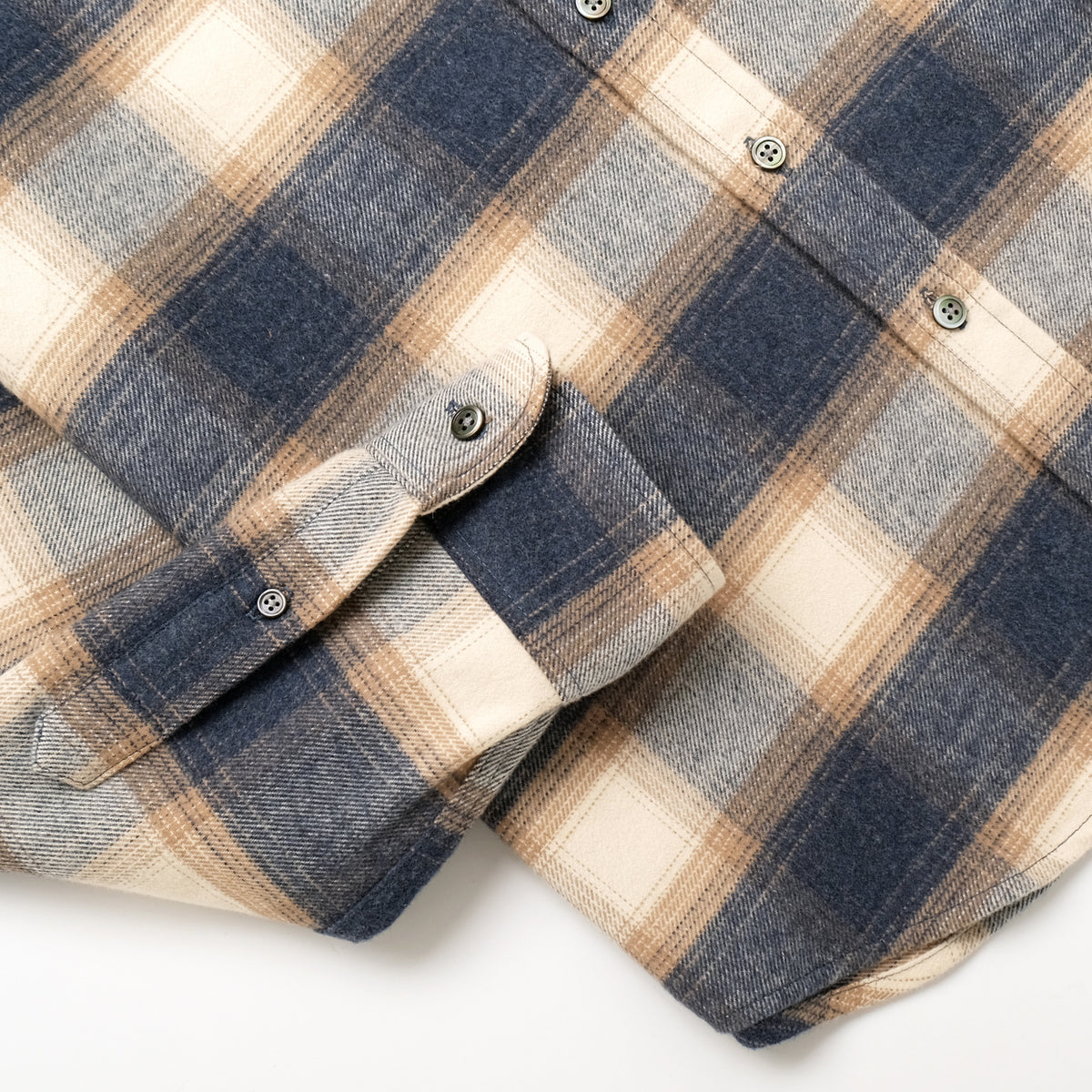 Blue and cream plaid flannel shirt sleeve with button cuff and seam