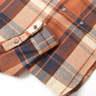 Plaid easy shirt sleeve cuff detail with buttoned tab, rust, navy, and cream