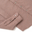 Micro check flannel shirt sleeve and cuff detail with brown button accents