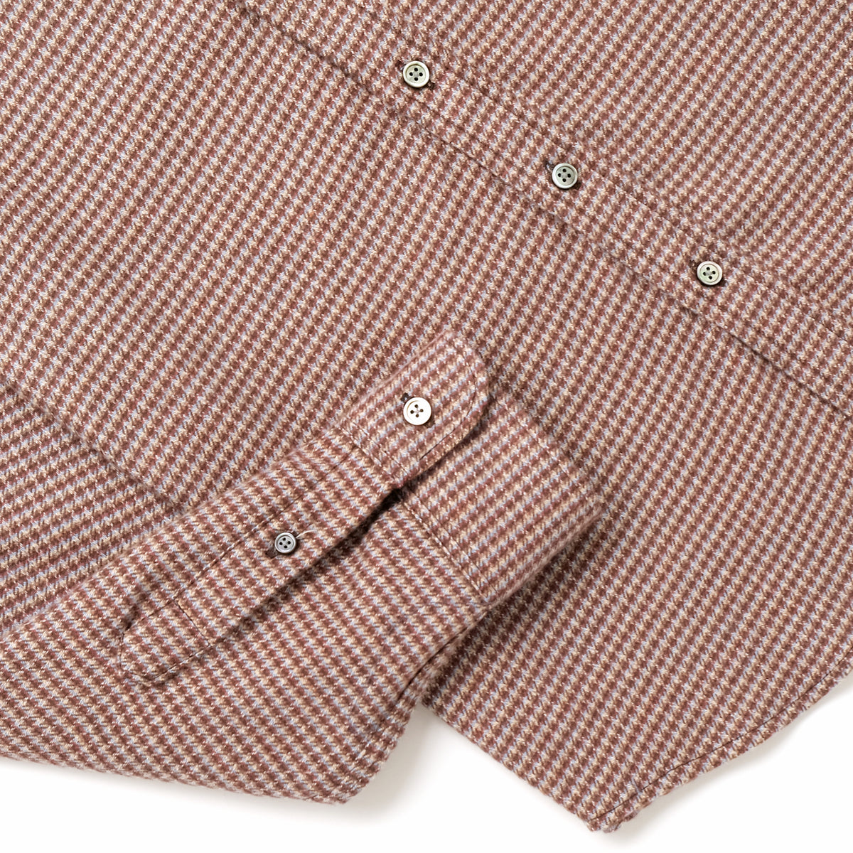 Micro check flannel shirt sleeve and cuff detail with brown button accents