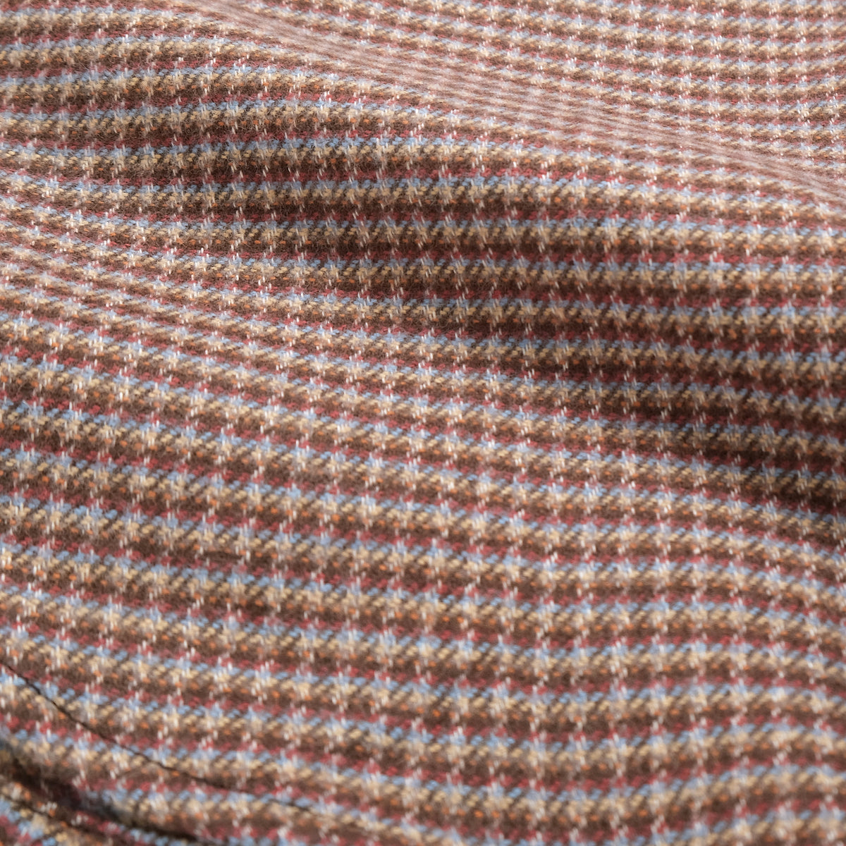 Micro check flannel fabric texture in brown with red and blue flecks