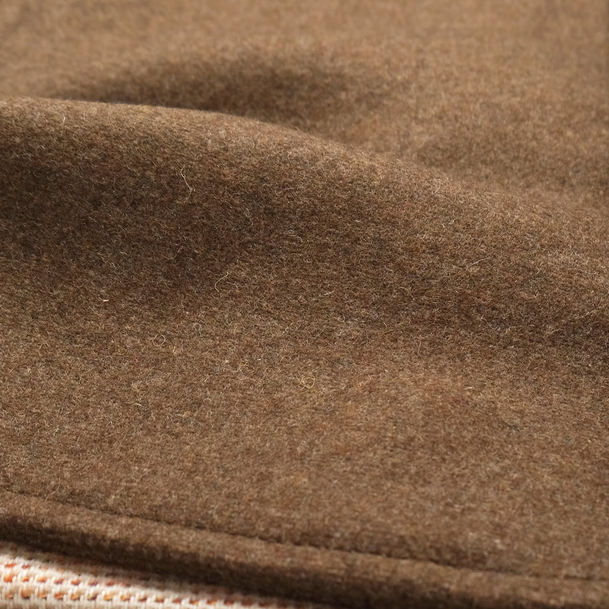 Close-up of brown stadium jacket fabric texture
