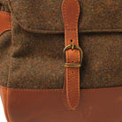 Front leather strap buckle on wool messenger bag with stitched edges