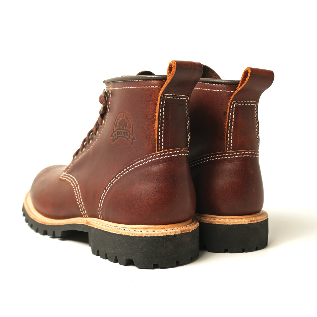 Brown leather hiking boots with heel pull loops, stitched panels, rugged tread soles.
