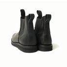 Black Chelsea boots rear view, elastic gore panels and low-profile rubber sole