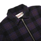 Plaid wool overshirt with zip-front and brand label at the collar