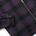 Plaid wool overshirt detail: buttoned chest flap and zipper